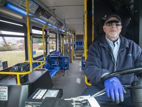 LTC bus driver Tim Pasma waits for people to board his empty number 13 Wellington Road bus at White Oaks Mall in London. (Free Press file photo)