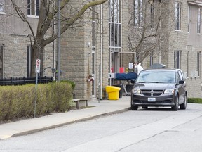 A man removes a body from  Anson Place Care Centre, a   long term care and retirement home Hagersville, on Sunday April 12, 2020. COVID-19 has killed 13 of its residents. Derek Ruttan/The London Free Press/Postmedia Network