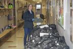 Amy Winders, who worked at Eagle Heights elementary school in London, helped distribute a large pile of Chrome books wrapped in plastic bags to studying-from-home pupils on April 15, 2020, the early days of the COVID pandemic. (Derek Ruttan/The London Free Press)