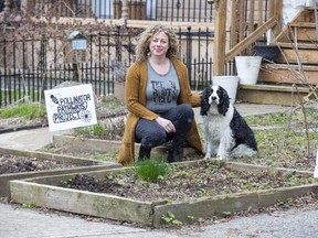 Marianne Griffith, shown with her dog Rudy, keeps her front yard vegetable garden in London irrigated by water from rain barrels. Griffith, a leader in the London Environmental Network, has a 10-year plan to make her home carbon neutral. (Derek Ruttan/The London Free Press)