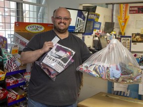 John-Paul Miller shows of some of the protective gear he has collected on behalf of #sewstrong at Ross Street Coin Laundry in St. Thomas on Friday April 17. (Derek Ruttan/The London Free Press)