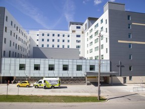 A paramedic prepares to unload an ambulance at the urgent care entrance of St. Joseph's hospital in London on Monday April 20, 2020. (Derek Ruttan/The London Free Press)