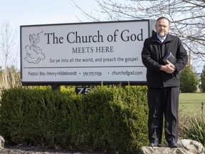 Pastor Henry Hiledebrandt will be using a trailer as a stage as he delivers the Sunday sermon at The Church of God in Aylmer, Ont. this weekend. The trailer faces the church parking lot where parishioners will be seated in their vehicles listening to the sermon on their FM radios. (Derek Ruttan/The London Free Press)