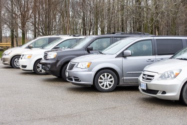 Parishioners sit in their vehicles while Church of God Pastor Henry Hildebrandt delivers a sermon from a stage in the church's parking lot in Aylmer, Ontario on Sunday April 26, 2020. In defiance of an order by the town's chief of police, the church held a drive-in service Sunday morning. Hundreds of parishioners sat in parked vehicles watching Hildebrandt on stage and listening to his sermon over their FM radios. Police video taped the event but have not yet laid charges. Derek Ruttan/The London Free Press/Postmedia Network