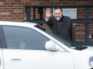 Church of God Pastor Henry Hildebrandt  waves to parishioners leaving  the church's parking lot in Aylmer, Ontario on Sunday April 26, 2020. In defiance of an order by the town's chief of police, the church held a drive-in service Sunday morning. Hundreds of parishioners sat in parked vehicles watching Hildebrandt on stage and listening to his sermon over their FM radios. Police video taped the event but have not yet laid charges. Derek Ruttan/The London Free Press/Postmedia Network