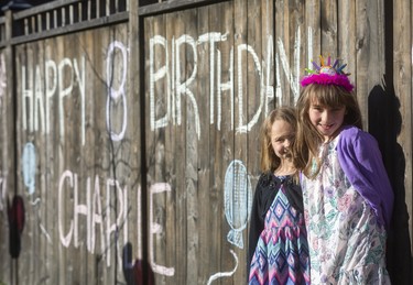 Charlie Rolo, 8 had here birthday celebrated with a parade down her street in old South with her little sister Allie Rolo 6, due to the COVID-19 a regular party couldn't be held so her mom Kyla Woodcock and her dad Paul Rolo, set up a drive by party instead in London, Ont.  Photograph taken on Thursday April 2, 2020.  Mike Hensen/The London Free Press/Postmedia Network