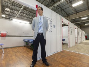 Ian Ball, a critical care doctor for London Health Sciences Centre, stands next to one of the rooms at the LHSC field hospital being constructed at the Western Fair District Agriplex in London. The 144-bed unit will treat patients who are on the mend from COVID-19 but not well enough to go home, said Ball. The unit can expand to 500 beds if the need arises. (Mike Hensen/The London Free Press)