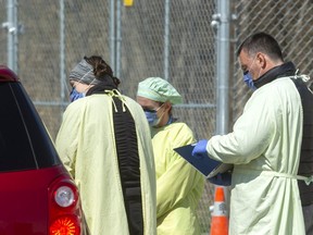 Nurses screen a visitor to the COVID-19 assessment centre at east London's Carling Heights Optimist community centre Wednesday, April 8. (Mike Hensen/The London Free Press)