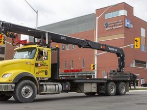 A long lineup of pickups, trucks and construction vehicles drives past the St. Thomas Elgin General Hospital in St. Thomas on Tuesday April 14, 2020 honking their horns to thank hospital staff. (Mike Hensen/The London Free Press)