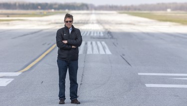 London International Airport president Mike Seabrook stands on its main runway, which sits empty for most of the day now as they've dropped from 30 flights a day, to one. (Mike Hensen/The London Free Press)