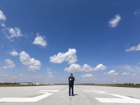 London International Airport president Mike Seabrook stands on their main runway, which sits empty for most of the day now. The virus crisis has reduced  traffic from 40 flights a day to two. (Mike Hensen/The London Free Press)