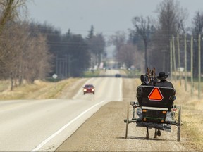 A Mennonite buggy heads along a country road near Listowel, north of London, in late April as life carries on in the midst of the pandemic. (Mike Hensen/The London Free Press)