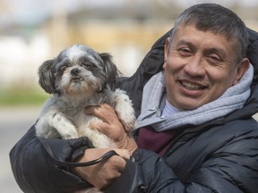 Jose Amabilis holds up a Shih Tzu named Carino who he got back after it had been stolen from outside his home in London, Ont.  Amabilis got the dog as a companion for his mom who suffers from dementia. Photograph taken on Wednesday April 22, 2020.  (Mike Hensen/The London Free Press)