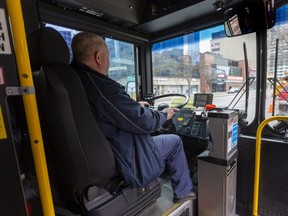 Bus drivers at the LTC are one group that has declined work to varying degrees in London, Ont. This driver obviously has not stopped providing the essential service. Photograph taken on Thursday April 23, 2020.  Mike Hensen/The London Free Press/Postmedia Network