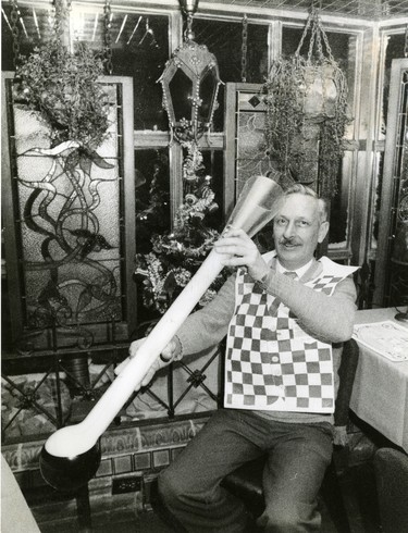 Pat Hebblethwaite, a bartender at the Latin Quarter, holds one of the restaurants features a yard of ale, 1985. (London Free Press files)