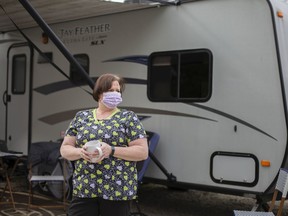 Monique Langlois, a personal support worker, stands outside an RV trailer she's living in to protect her family from contracting COVID-19, Tuesday, April 14, 2020.