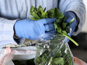 A vendor prepares spinach at a farmers market in Maryland.