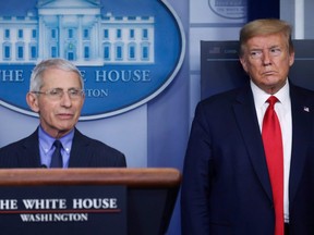 U.S. President Donald Trump looks at National Institute of Allergy and Infectious Diseases Director Dr. Anthony Fauci as Fauci answers a question during the daily coronavirus task force briefing at the White House in Washington, U.S., April 17, 2020. (REUTERS/Leah Millis)