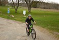 London resident Elena Nardozzi rides through Wildwood Conservation Area Thursday afternoon, around the same time the province announced private campgrounds and marinas will be able to re-open for businesses as of 12:01 a.m. May 16. (Galen Simmons/The Beacon Herald)