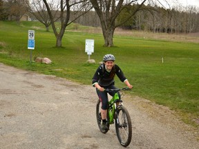 London resident Elena Nardozzi rides through Wildwood Conservation Area Thursday afternoon, around the same time the province announced private campgrounds and marinas will be able to re-open for businesses as of 12:01 a.m. May 16. (Galen Simmons/The Beacon Herald)