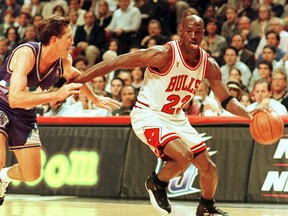 In this 1997 file photo, Michael Jordan of the Chicago Bulls goes past Jeff Hornacek of the Utah Jazz during the NBA Finals at the United Center in Chicago. (Vincent Laforet/AFP via Getty Images).