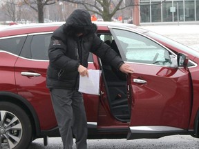 Claude Eric Trachy keeps his face hidden as he arrives at the Chatham courthouse for trial on sex charges in April 2018. (Files)