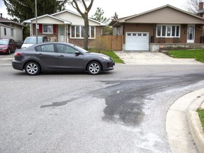 A stained patch of road at Jalna Boulevard and Poplar Crescent marks the scene of a deadly motorcycle collision, one of two fatal motorbike crashes in the city in less than 12 hours, on Monday, May 4. (Derek Ruttan/The London Free Press)