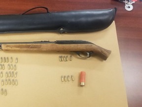 London police seized a rifle and ammunition from a Marconi Boulevard home on Thursday. A man is charged. (London police photo)