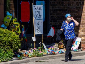 An employee departs from Orchard Villa Retirement Residence after several residents died of the coronavirus disease (COVID-19) in Pickering, Ontario, Canada May 26, 2020.  (REUTERS/Carlos Osorio)