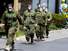 Members of the Canadian Armed Forces in front of Pickering's Orchard Villa long-term care home.