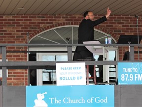 Pastor Henry Hildebrandt delivers a sermon on Sunday during a drive-in service at the Church of God in Aylmer, where congregants celebrated the provincial government's move to allow religious groups to hold the parking lot gatherings amid the COVID-19 pandemic. DALE CARRUTHERS / The London Free Press