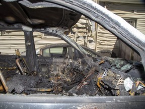 Fire destroyed two vehicles and damaged homes on English Street in Old East Village Wednesday. (Derek Ruttan/The London Free Press)