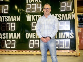 Jeff Stewart, CEO of OES Inc., with a cricket score board Mae by the company in London, Ont. Photo shot on Wednesday May 20, 2020. Derek Ruttan/The London Free Press/Postmedia Network