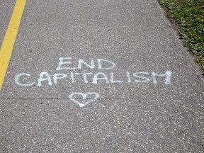 Several messages in spray paint have appeared on the road and bike path in Greenway Park  in London, Ont. Photo shot on Thursday May 21, 2020. Derek Ruttan/The London Free Press/Postmedia Network