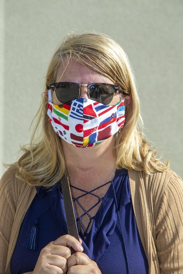 Sue Birtch, London. The mask was made by Marsha Haggarty who is selling them for $10 a piece with all proceeds going to My Sister's Place. "The whole world is in the same fight and this mask symbolizes that." Photo shot  in London, Ont. on Wednesday May 27, 2020. Derek Ruttan/The London Free Press/Postmedia Network