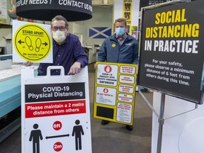 Mike Froome and Matt Boos of M&T Printing show just a few of the products that are keeping them busy in London during the COVID-19 pandemic.   Mike Hensen/The London Free Press/Postmedia Network