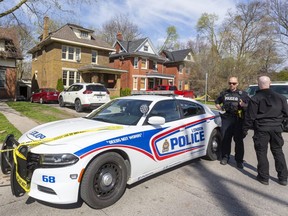 Police taped off a house at the northwest corner of Talbot and Oxford streets early on Saturday. Police say the house was targeted by gunfire. (Mike Hensen/The London Free Press)