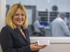 Manon Hogue, CEO of Diagnostics Biochem Canada Inc. in London, holds a COVID-19 antibodies test kit the company has developed and is seeking approval for. (Mike Hensen/The London Free Press)