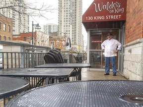 Mark Kitching's mood matches the weather as he surveys his empty patio on a soggy Thursday afternoon May 14, 2020.  The city is considering allowing restaurants to expand their patios to allow for distancing, once restaurants are allowed to reopen. (Mike Hensen/The London Free Press)