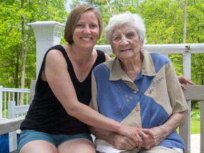 Shawna Labonte-Rudy sits with her grandmother Una Fulcher, 99, who survived a bout with COVID-19 and now lives with them near Mt. Brydges west of London, Ont.  Photograph taken on Monday May 25, 2020.  Mike Hensen/The London Free Press/Postmedia Network