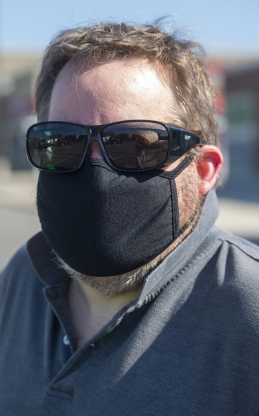 Stephan Vachon, 49 of London, said about his mask, "it just arrived in the mail 2 days ago, I used to wear a bandana but it got so hot. This is my first time wearing it, I'll get used to it, it's the new reality." Photograph taken on Tuesday May 26, 2020.  Mike Hensen/The London Free Press/Postmedia Network