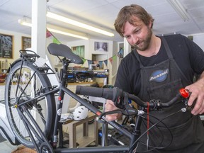 Ben Cowie, owner of the London Bicycle Cafe on Clarence Street in London says he's never been busier than he is now with stock flying out the door and people bringing in their bikes to get them back on the road in London. (Mike Hensen/The London Free Press)