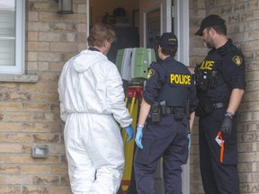 OPP forensic identification officers scan the interior of the home at 39 Leesboro Trail in Thorndale Thursday where a body was found Tuesday in the village northwest of Thamesford.  Mike Hensen/The London Free Press)