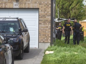 OPP erect a tent in the backyard of a house at 39 Leesboro Trail in Thorndale northeast of London, on Friday. OPP have been on the scene, where a body was found, since Tuesday. Photograph taken on Friday May 29, 2020.  (Mike Hensen/The London Free Press)