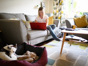 Crisis centre volunteer Nichola Seaward works from the living room of her home earlier this month in Newbury, U.K. Work from home is gaining speed during the pandemic, but who is bearing the costs, such as extra space and a proper work station? (Getty Images)