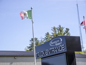 A Mexican flap flies outside of ScotLynn Group, a farm operation that produces corn, watermelon, asparagus and pumpkins in Vittoria, Ont. Migrant workers there have tested positive for COVID-19. Derek Ruttan