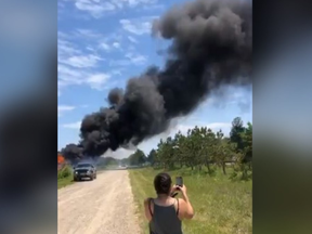 Smoke rises from the remains of a shop on Kettle and Stony Point First Nation Friday, in this screenshot from a video posted to Facebook by a member of the First Nation. Tensions flared as members of the First Nation moved to evict operators at smoke and cannabis shops on former Camp Ipperwash land.