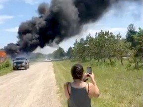 Smoke rises from the remains of a shop on Kettle and Stony Point First Nation June 19, in this screenshot from a video posted to Facebook by a member of the First Nation. Tensions flared as members of the First Nation moved to evict operators Friday at smoke and cannabis shops on former Camp Ipperwash land.