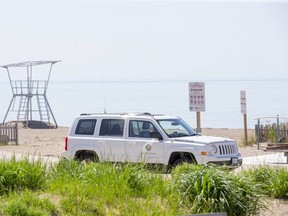 A Lambton Shores bylaw enforcement vehicle is park on the beach in Grand Bend, Ont. on Tuesday, June 2, 2020. Bylaw officers are patrolling the closed beach. (Derek Ruttan/The London Free Press)