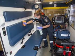 Paramedics like Tara Cressman give their ambulances a thorough cleaning after unloading patients. (Derek Ruttan/The London Free Press)